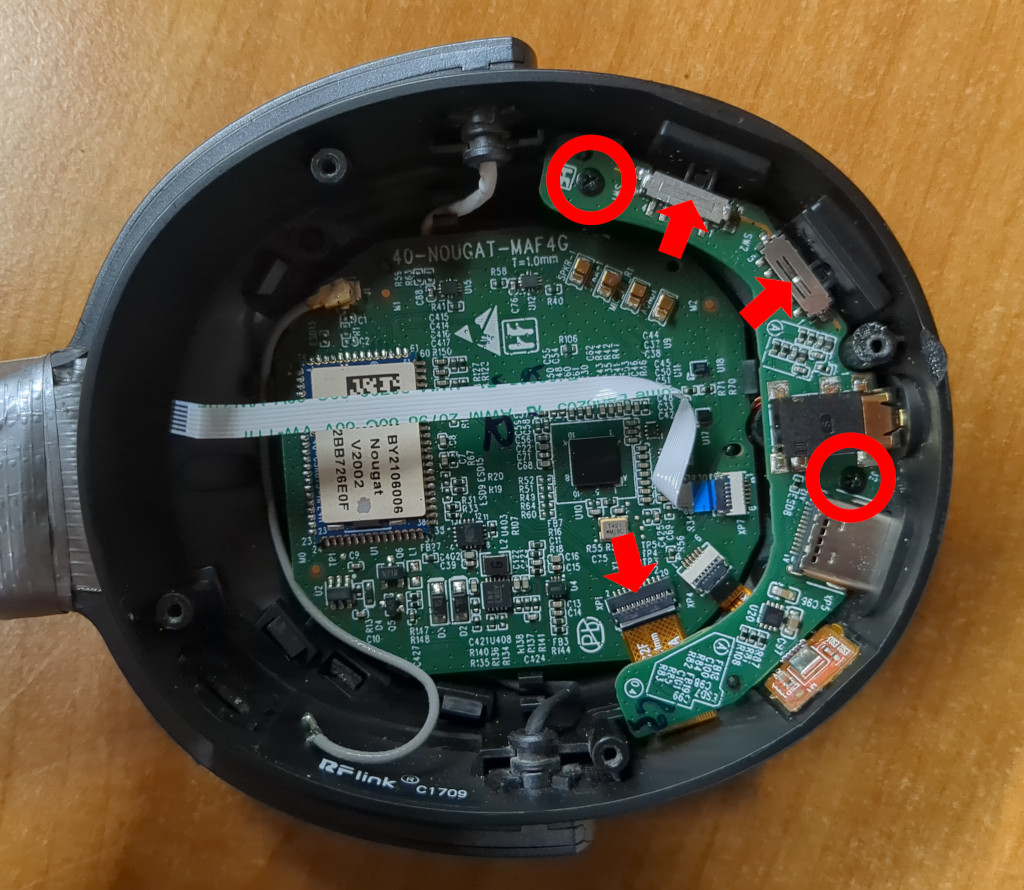 Main PCB and daughter board on the inside of the ear cup. The ribbon cable, two screws and loose buttons on the daughter board are marked.